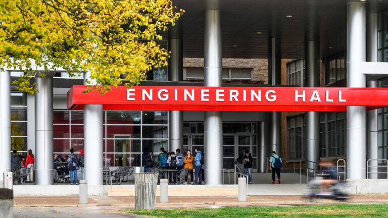 Students line up to speak to Tesla recruiters in front of Engineering Hall at the University of Wisconsin–Madison during a mild and periodically rainy autumn day on Oct. 11, 2022. (Photo by Althea Dotzour / UW–Madison)