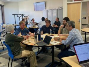 Instructors sitting around a table talking